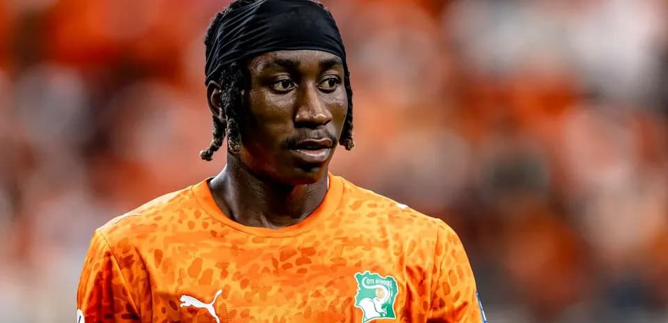 Jugador de fútbol con camiseta naranja en el campo