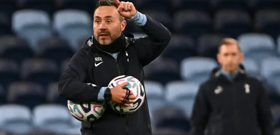 Entrenador dirigiendo instrucciones con balones en brazos