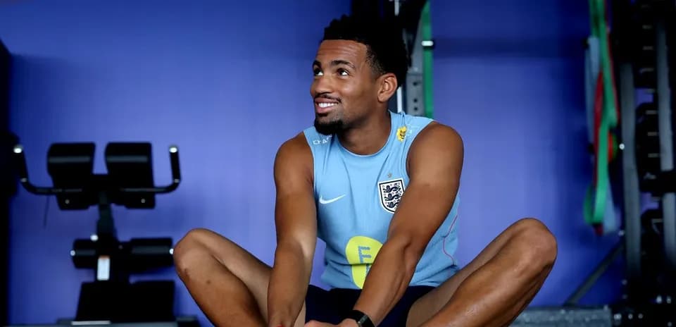 Jugador estirándose en gimnasio durante entrenamiento