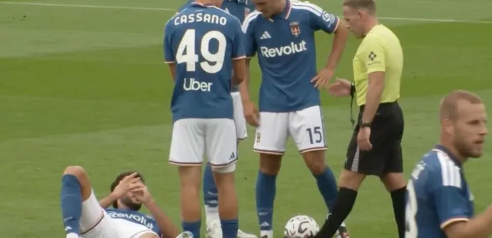 Jugador caído en el campo durante partido de fútbol