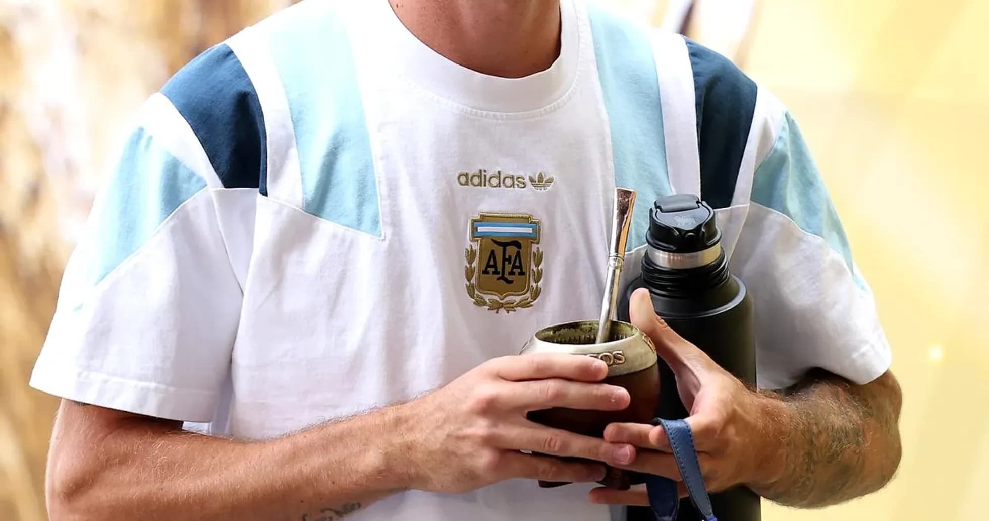 Jugador sosteniendo mate y botella en vestíbulo