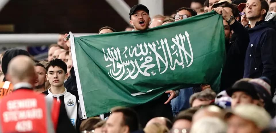 Afanático sostiene una bandera de Arabia Saudita en las gradas