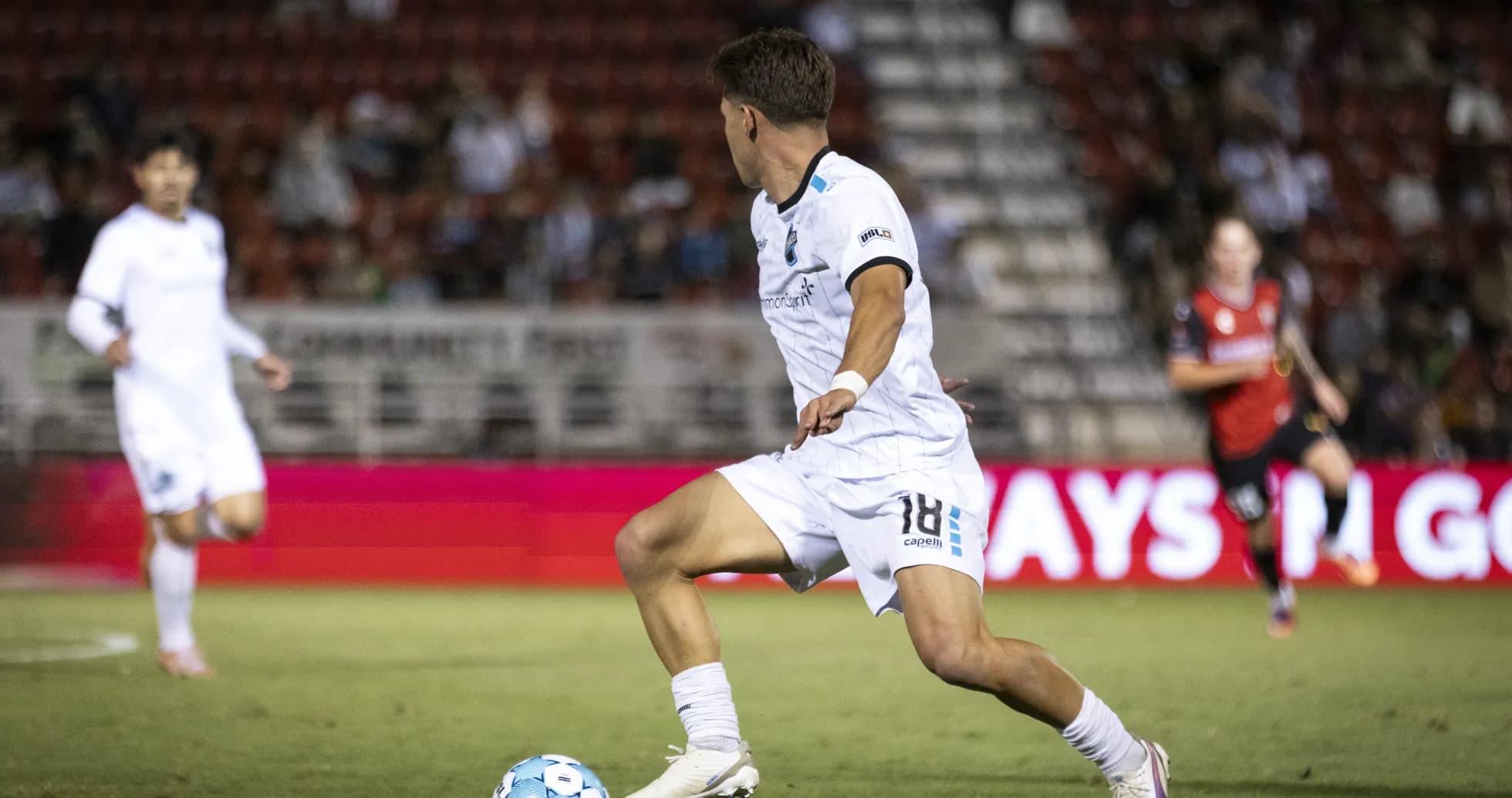 Jugador corriendo con el balón en el partido