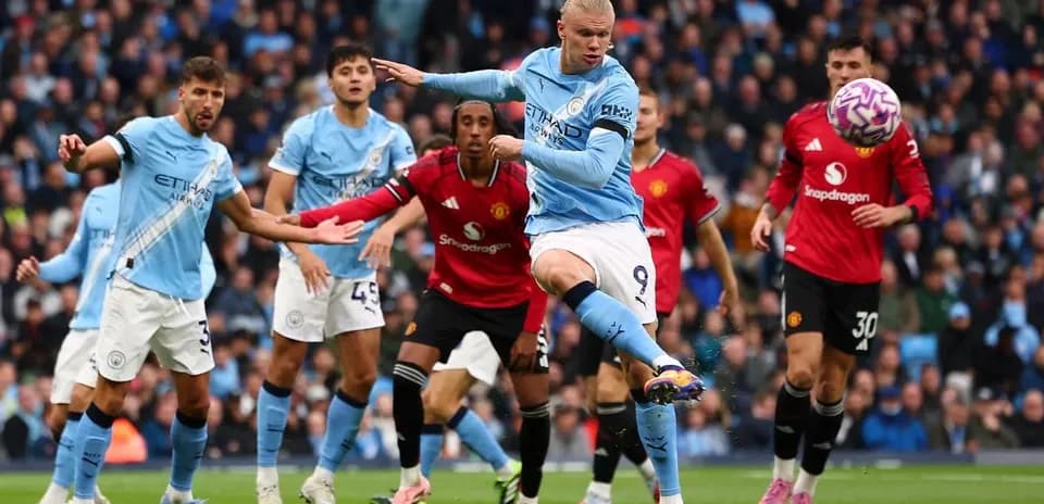 Erling Haaland kicking the ball during Manchester derby