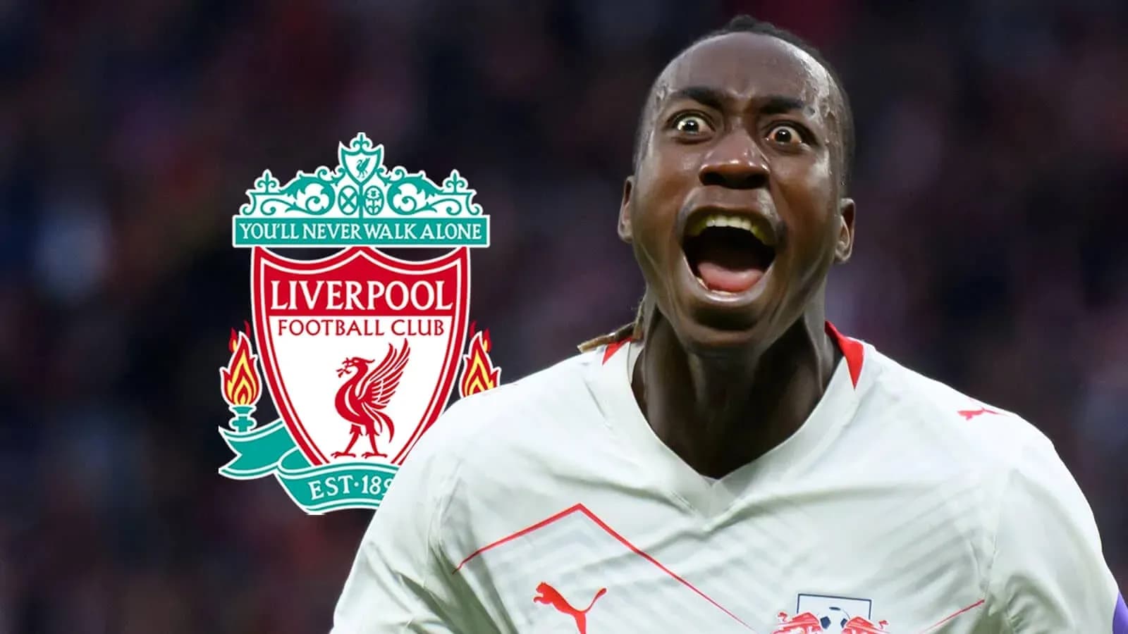 Jugador celebrando frente al escudo de Liverpool