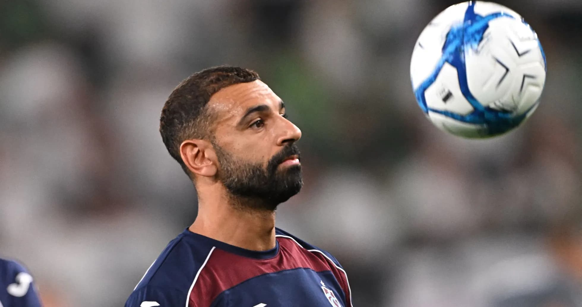 Jugador practicando con balón antes del partido