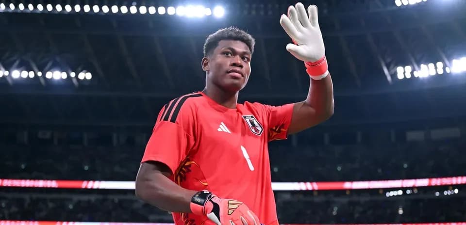 Portero saludando con guantes en el campo