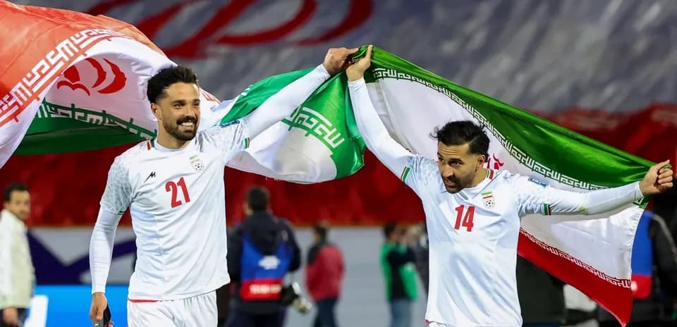 Jugadores de Irán celebrando con banderas