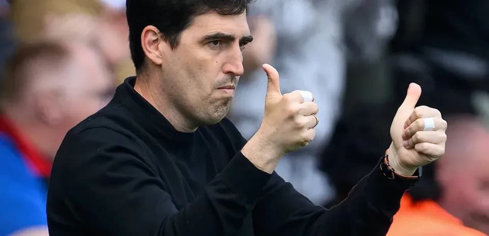 Entrenador dando pulgares arriba en el banquillo