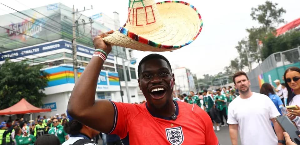 Fan wearing England jersey and sombrero at event Fan wearing England jersey and sombrero at event