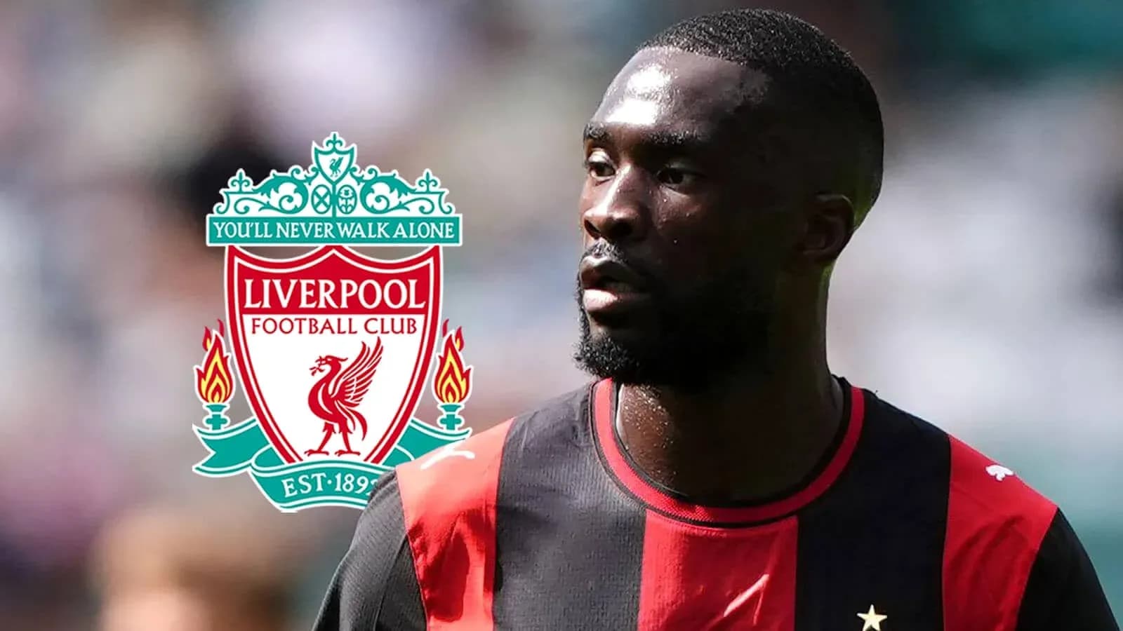Jugador con camiseta negra y roja junto a logo de Liverpool Jugador con camiseta negra y roja junto a logo de Liverpool