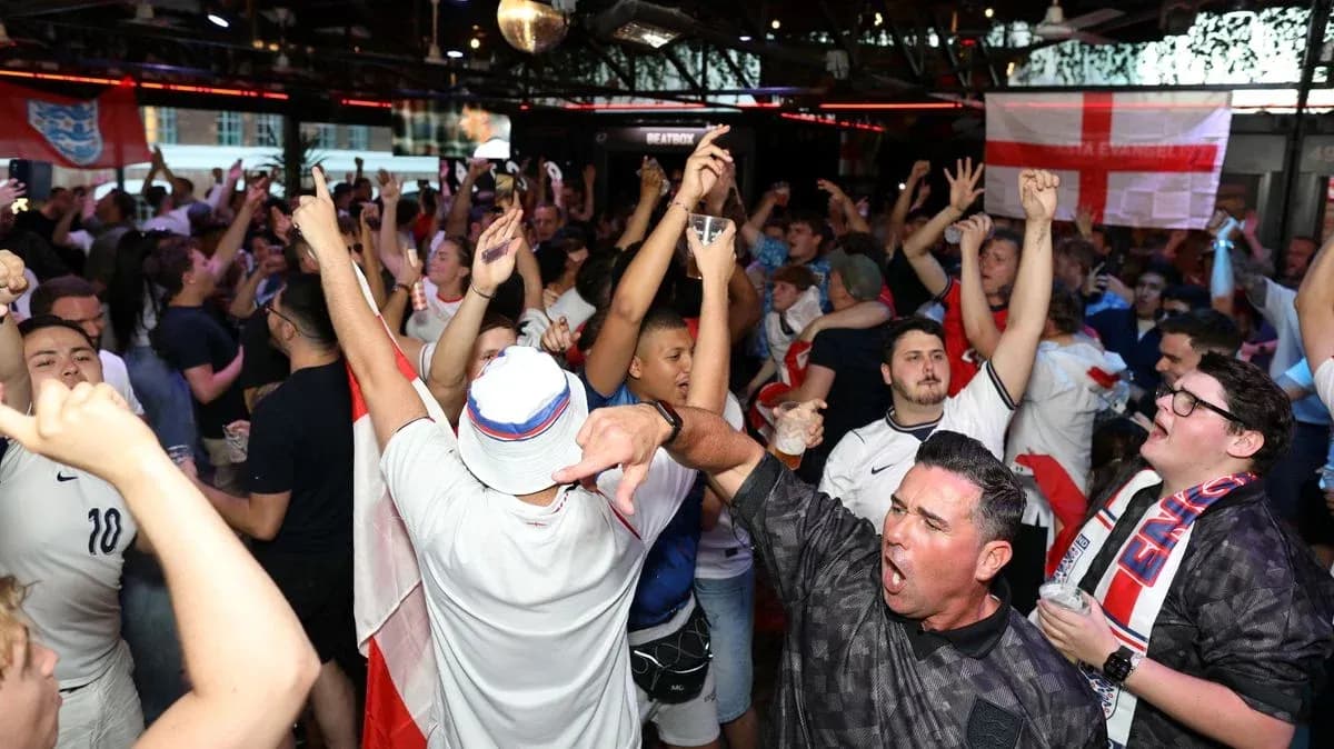 A crowd of fans celebrating in a bar A crowd of fans celebrating in a bar